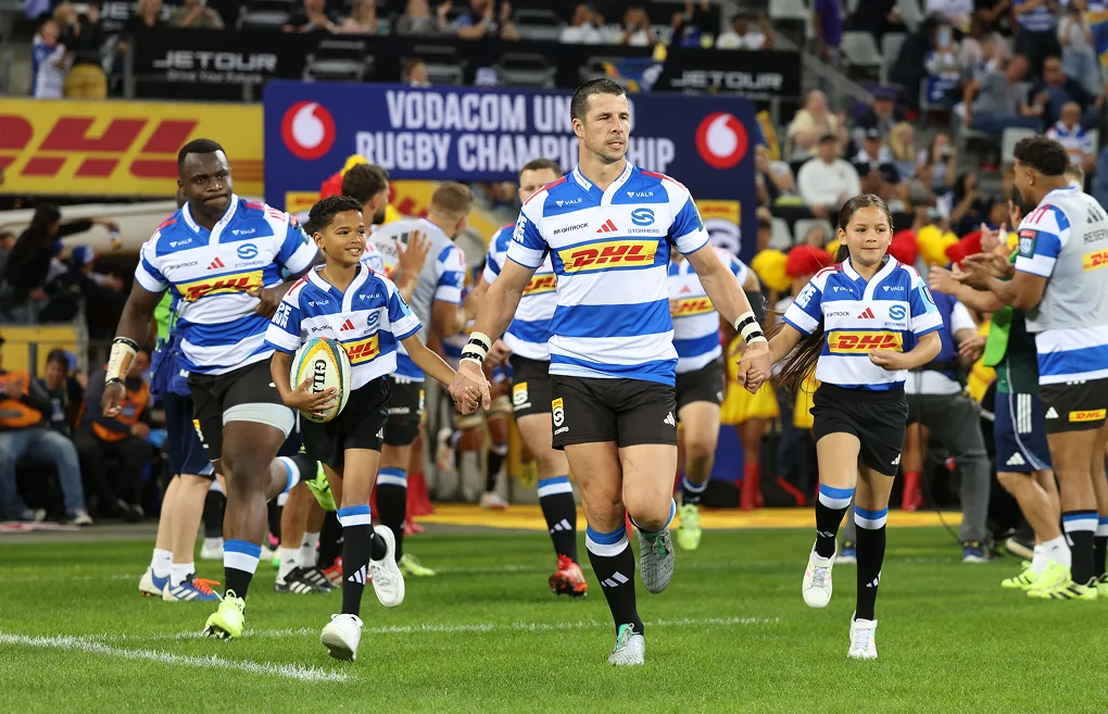 DHL Stormers running onto the pitch holding hands with members.