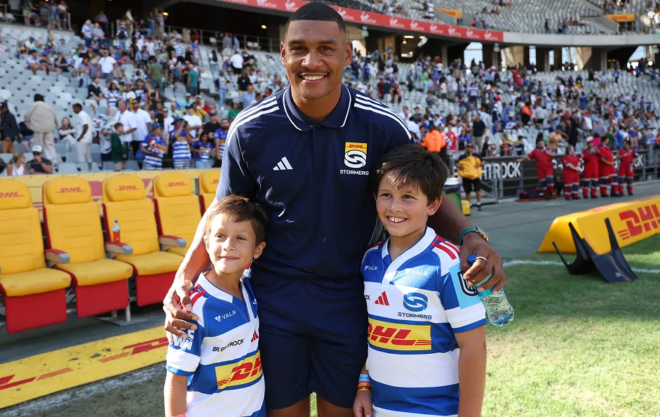 DHL Stormers player with two young members pitchside