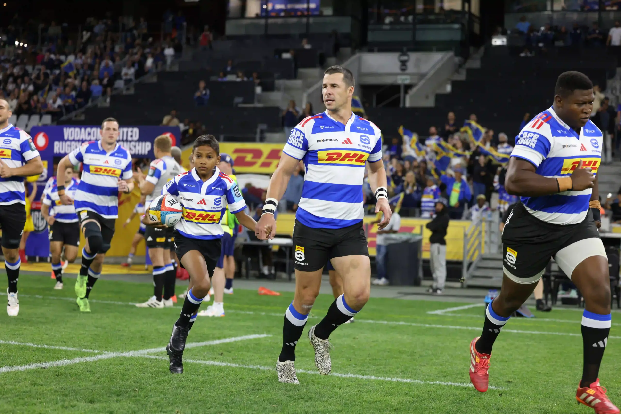 Kid Mascot runs out with Ruhan Nel